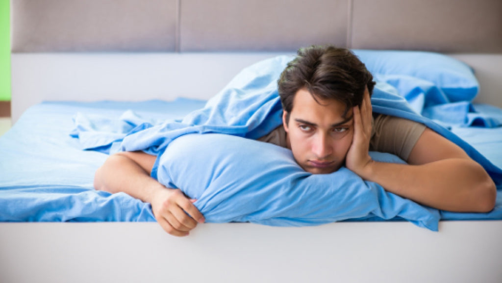 Image of Man sleepless in a bed - Fosters Mattress Blog Post